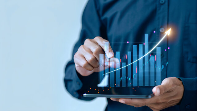 Businessman analyzing financial growth data with rising bar charts on digital screen symbolizing investment success, corporate strategy, stock market performance, and economic development