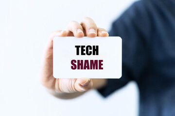 Tech shame text on white blank card holding by hand isolated on white background
