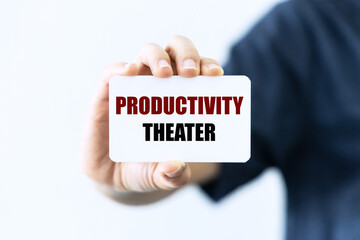 Productivity theater text on white blank card holding by hand isolated on white background