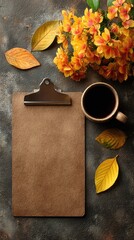 Autumnal flatlay with clipboard, coffee, and flowers