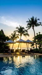 Tropical resort pool at sunset