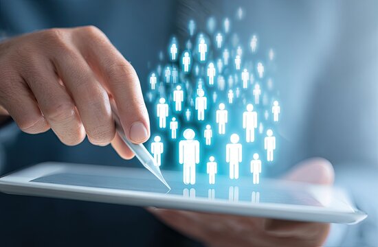Close-up of a hand holding a tablet, interacting with a holographic representation of people