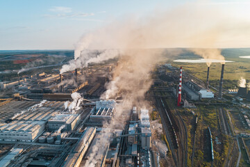 Air pollution from industrial facilities causes environmental concerns in urban areas during sunset...