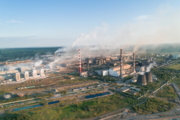 Air pollution from industrial facilities causes environmental concerns in urban areas during sunset...