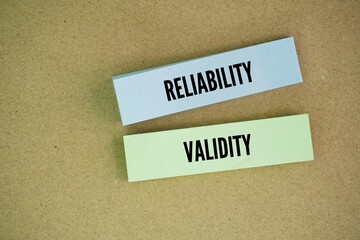 Colored paper with the words reliability and validity. Reliability refers to the consistency of a measure, while validity refers to the accuracy of a measure.
