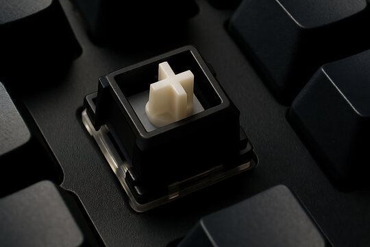 Macro shot of a mechanical keyboard switch with keycap removed, showing cross stem detail.
