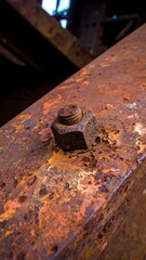 Rusty metal beam with bolt