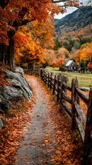 Naklejka premium Autumnal path, leaves strewn, rustic fence, distant cabin, mountains