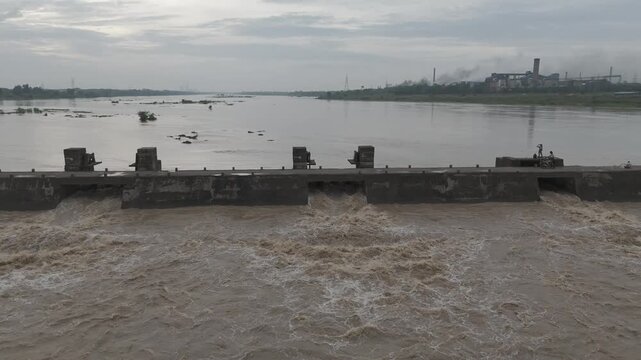 dam water release, river flood water flow, powerful water stream, overflowing barrage gates stock video.