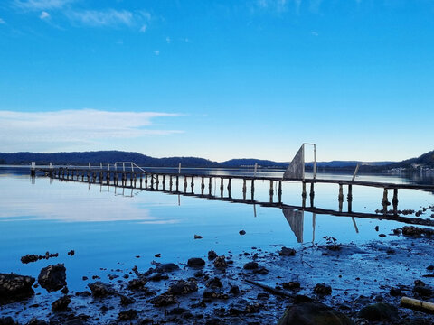 Derelict fishing jetty at Kincumber on the NSW Central Coast. with beautiful reflections. Taken on the Kincumber to Davistown Walk, New South Wales, Australia.
