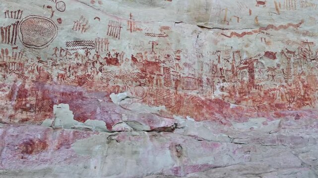 Camera passing by the stunning ancient rock paintings at Cerro Azul in the Guaviare department in Colombia