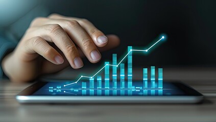 Hand interacting with a tablet displaying a rising bar graph