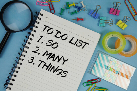 So Many Things in To Do List text with magnifying glass on blue background - Powered by Adobe