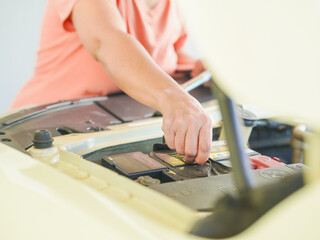 Close up technician hands at work repair car in garage at house holiday. Person activity family home for concept mechanical, transportation, working family. Mothers at home. Technician fix vehicle 