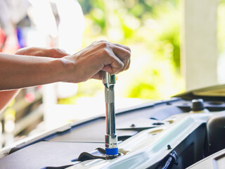 Close up technician hands at work repair car in garage at house holiday. Person activity family home for concept mechanical, transportation, working family. Mothers at home. Technician fix vehicle 