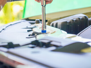 Close up technician hands at work repair car in garage at house holiday. Person activity family home for concept mechanical, transportation, working family. Mothers at home. Technician fix vehicle 