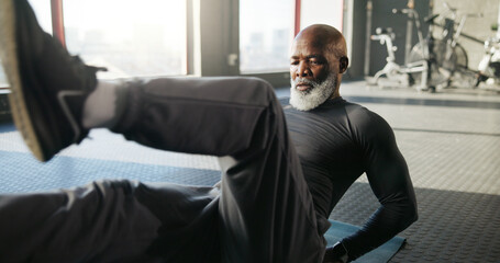 Legs, exercise and mature black man in gym for core strength, workout and training on floor. Sports...