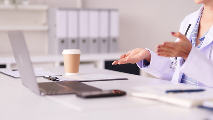 Female doctor provides medical consultation to patient in modern clinic office healthcare professional discussing treatment and wellness advice