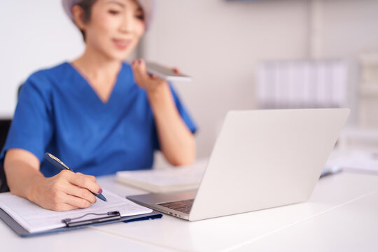 Asian Female Healthcare Professional Documenting Patient Information Virtual Consultation Medical Office