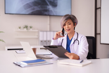 Asian adult doctor medical professional consult patient healthcare using mobile device technology modern clinic hospital office work environment expert advice telehealth communication