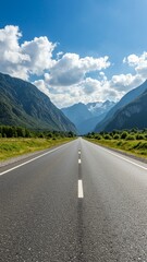 Straight asphalt road through mountainous landscape, vertical image