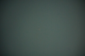 Texture and background of dark green finish called Fenix ​​NTM Solid Verde Comodoro.  