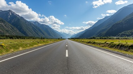 Straight asphalt road through mountainous landscape