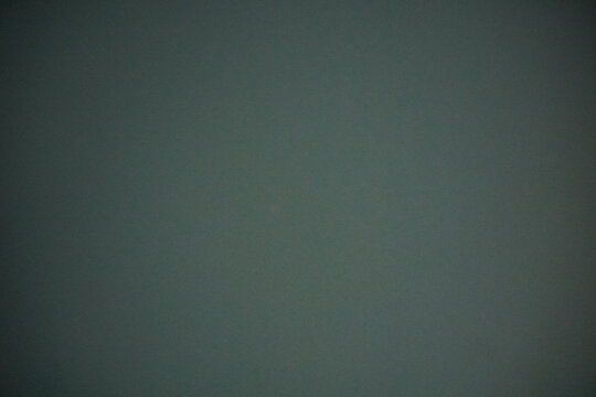 Texture and background of dark green finish called Fenix ​​NTM Solid Verde Comodoro.  