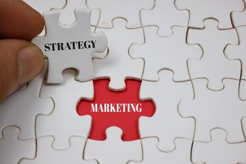 Puzzle Concept Depicting Strategy Marketing with Highlighted red Piece	