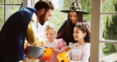 Children, happy or sweets at door on halloween for tradition, celebration and trick or treat. Festival, people or neighborhood kids with bucket at house for candy collection, snack or fantasy costume