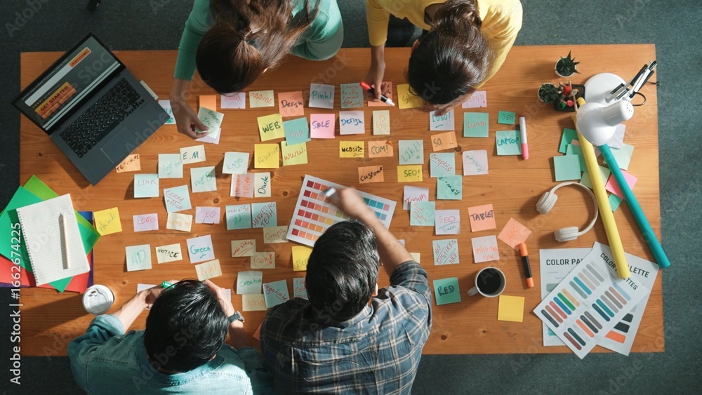 Aufkleber group of creative team looking and planning idea while manager holding sticky notes and presenting m