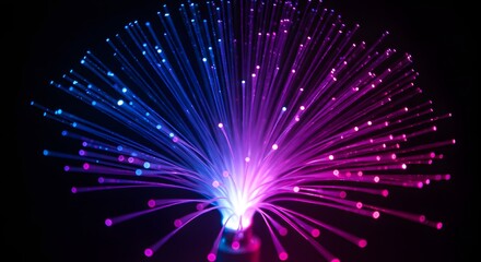 Fiber optic light cables creating a burst of vibrant colors on a dark background