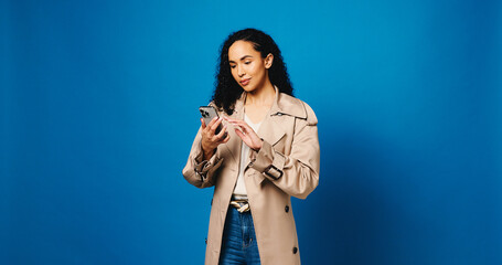 Phone, reading and typing with woman in studio for connection, text message and social media....