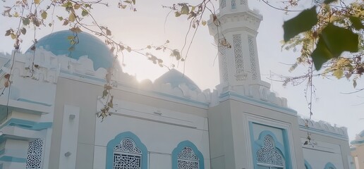 Cinematic view of a mosque's dome, framed by lush leaves.