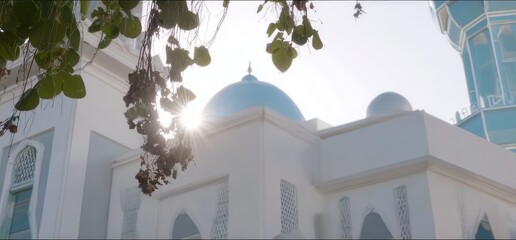 Cinematic view of a mosque's dome, framed by lush leaves.