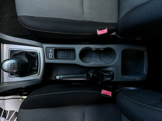 The modern car interior features an advanced console equipped with a sixspeed manual gear shifter...