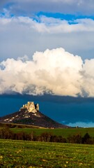 Naklejka premium Hilltop Castle Under Cloudy Sky