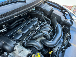This is a closeup view that captures the intricate details of a modern automotive engine bay,...