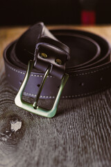 An exquisite and stylish brown leather belt featuring a sleek metal buckle, beautifully showcased...