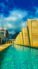 Experience the beauty of an Architectural Infinity Pool surrounded by elegant buildings and vibrant...