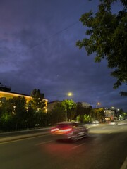 City at Night Urban Landscape of Cars Streaking Through the Evening with a Dramatic Sky