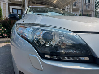 This is a closeup view showcasing a modern car headlight that features a sleek design complemented...