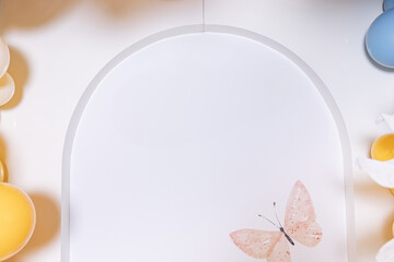 A beautifully arranged display of delicate butterflies alongside an array of colorful Easter eggs...