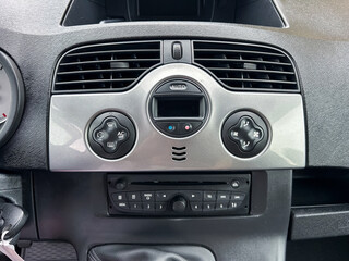 The modern car dashboard control panel is equipped with an advanced air conditioning system and an innovative audio system, providing users with comfort and entertainment while driving