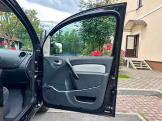 The sleek and fashionable interior of a contemporary car stands in striking contrast to a...