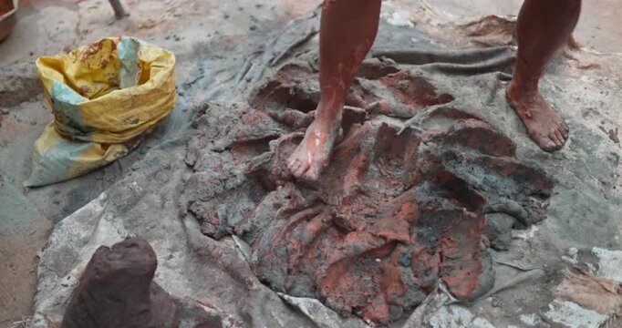 Indian Clay Artist: Preparing Clay with Feet for Ganesh Idol Making