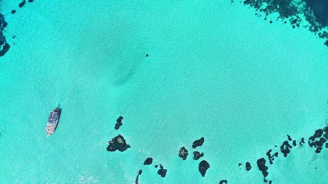 4k drone video of Garip and Kalem islands with turquoise sea and coral reefs in Bademli. Dikili, a district of Izmir famous for its turquoise sea in Turkiye.