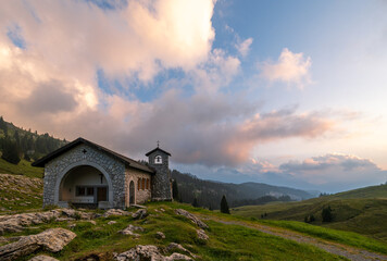 The stone chapel on the high Alps mountain at sunset over the Pragel Pass in Canton Schwyz,...