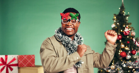 Portrait, black man and dancing in studio for Christmas holiday, xmas party and celebration. Smile,...