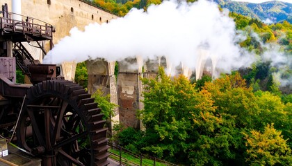 Antique steam-powered mill amidst autumn foliage
